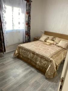 a bedroom with a large bed with a window at Appartement boulevard Mohamed 5 in Tangier