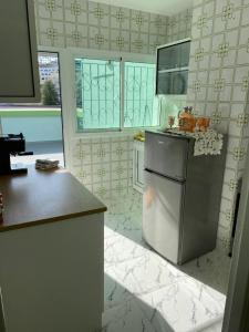 a kitchen with a refrigerator and a counter top at Appartement boulevard Mohamed 5 in Tangier