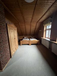 an attic room with two beds and a brick wall at Attraktiver Luftkurort Winterberg in Winterberg