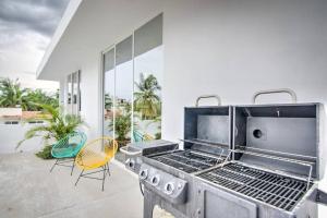 a kitchen with a grill and chairs on a patio at Las Vueltas - Golden Zone Studio 2 Blocks to Beach in Bucerías