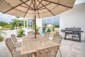 a table and chairs with an umbrella and a grill at Las Vueltas - Golden Zone Studio 2 Blocks to Beach in Bucerías +29 photos