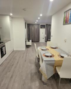 a dining room with a table and chairs at 3 Bedrooms 2baths 3 toilets Excel City Airport O2 Sleeps up to 7, in London