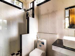 a bathroom with a toilet and a sink at LA PETITE MANGROVE Resort in Phumĭ Srângam +37 photos