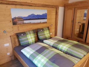 a bedroom with two beds in a log cabin at Chalet Steinplatte in Reit im Winkl