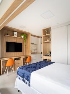 um quarto com uma cama grande e uma televisão em Apto decorado NOVO Moema em São Paulo