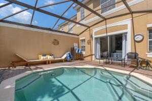 a swimming pool in front of a building with a window at Wish Upon A Splash - Family Villa - 3BR - Private Pool - Disney 4 miles in Kissimmee