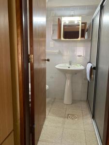 a small bathroom with a sink and a toilet at Agua Viva in Piriápolis