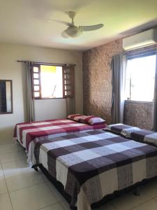 En eller flere senge i et værelse på Paraíso dos Oliveira