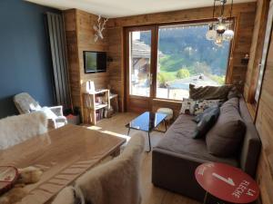 a living room with a couch and a table at Appartement Le Grand-Bornand, 3 pièces, 5 personnes - FR-1-458-174 in Le Grand-Bornand