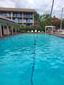 a large swimming pool in front of a hotel at Kihei Kai Nani Resort in Kihei