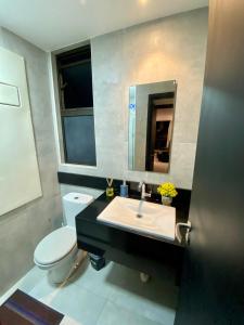 bagno con lavandino, servizi igienici e specchio di Barra Home Stay - Beira mar - 2 QUARTOS a Recife