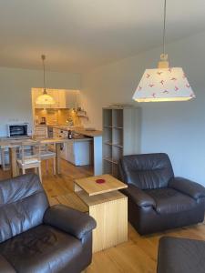 a living room with a couch and a table at Appartement Raineck in Mittenwald