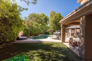 a backyard with a swimming pool and a house at Scottsdale Escape - Pool, Spa, Firepit, & Pool Table in Phoenix