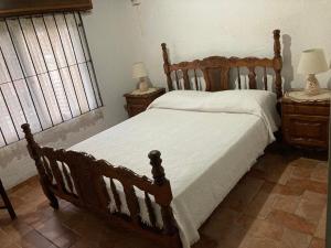 a bedroom with a wooden bed and two night stands at Catador 1 in Barra del Chuy