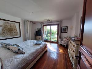 a bedroom with a bed and a large window at Villa Castello in Bodrum City