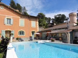 a swimming pool in front of a house at Les 13 Chimères in Nice