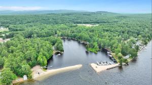 an aerial view of a lake with trees and a island at CRYSTAL OASIS- LIMIT 8 villa in North Sebago