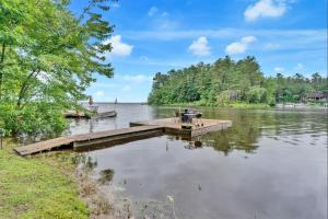 a dock on a lake with two boats at CRYSTAL OASIS- LIMIT 8 villa in North Sebago
