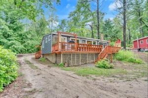 a house with a deck on a dirt road at CRYSTAL OASIS- LIMIT 8 villa in North Sebago
