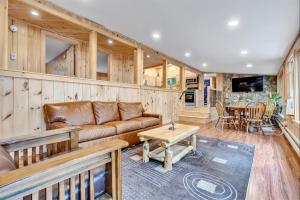 a living room with a couch and a table at CRYSTAL OASIS- LIMIT 8 villa in North Sebago +14 photos