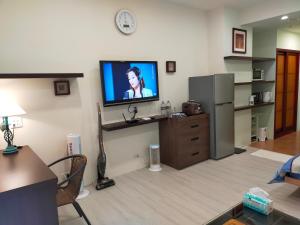 uma sala de estar com televisão na parede em 知本溫泉家 em Hua-yüan