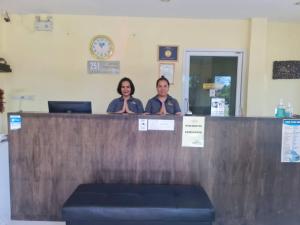 two people standing at a counter in a practition at Chom By The Sea in Ao Nam Mao