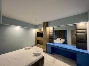 a bedroom with a bed and a large mirror at Aurora apartments on the beach in Obzor