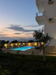 a view of a swimming pool at night at Cold Bay Mansion in Bar