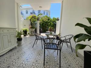 a patio with chairs and a table in a room at Aroma home in Da Nang