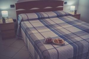 a bed with a plate of food and a camera on it at La casa di Emma in Terni