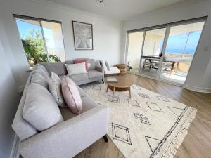 a living room with a couch and a table at Sailors View Kalbarri in Kalbarri