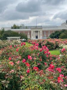 a building with a field of flowers in front of it at Private Los Angeles Room - Free WIFI, AC, TV, Private Fridge, Kitchen, near USC - Exposition Park - USC Memorial Coliseum - Banc of California BMO Stadium - Downtown Los Angeles DTLA - University of Southern California USC!!! in Los Angeles