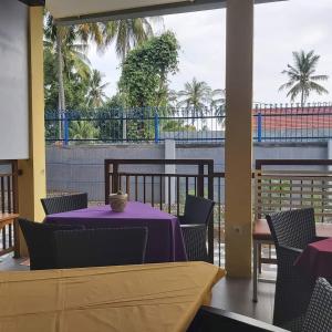 a table with a purple table cloth on a balcony at KJ Inn Homestay Senggigi in Senggigi