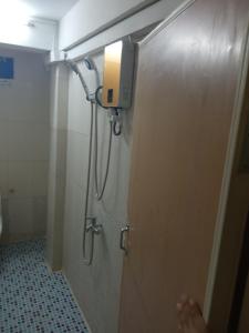 a shower in a bathroom with a door with a light at 华越宾馆 in Phnom Penh