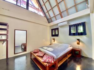 1 dormitorio con 1 cama y tragaluz grande en Emerald House Village en General Luna