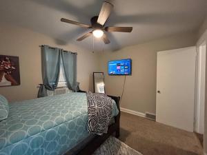 a bedroom with a bed and a ceiling fan at Cozy Home Close To, State Street and Downtown in Rockford