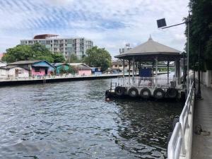a river with a pier with a pavilion on it at CB's - Cheap Boutique Bangkok in Bangkok