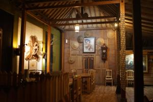 a dining room with a table and plates on the wall at Tirta Arsanta Hot Springs & Villa in Bogor