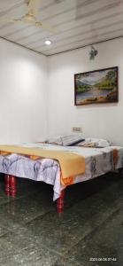 a large bed in a white room with avertisement at Floral Homestay in Thekkady