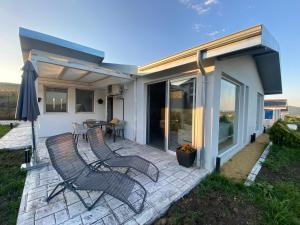 a patio with two chairs and a table on it at villas 21,22 Albena sea view in Rogachevo