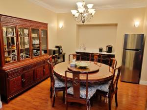 a kitchen with a dining room table and a refrigerator at Green Leaf B&B in West Kelowna