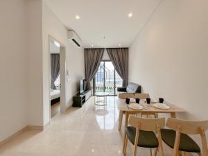 a living room with a table and chairs at Lucentia Residences BBCC at Lalaport Kuala Lumpur by Veedu Hauz in Kuala Lumpur