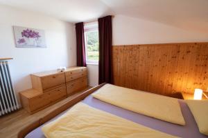 a small bedroom with a bed and a window at Melaniesguesthouse 4 Zimmerwohnung in Caldaro