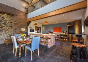 a kitchen and dining room with a table and chairs at Ty Nain in Pwllheli