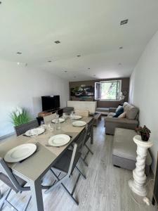 a living room with a table with chairs and a couch at Romantic villa in the south of France with a private garden , pool and a terrace in Nice