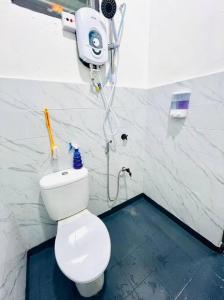 a bathroom with a toilet and a shower at Double Storey terrace house in Sandakan Sabah in Sandakan