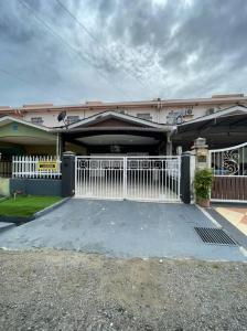 a house with a white gate in front of it at Double Storey terrace house in Sandakan Sabah in Sandakan
