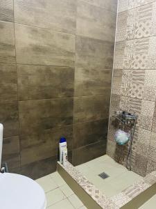 a bathroom with a shower with a glass door at Natia rooms in Tbilisi City