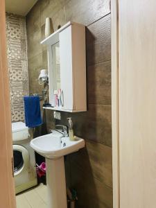 a bathroom with a sink and a toilet at Natia rooms in Tbilisi City