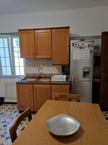 a kitchen with a wooden table with a bowl on it at Delizioso appartamento al centro di Bosco SAN GIOVANNI A PIRO in Casal Sottano